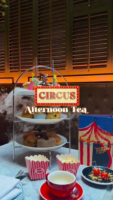 A promotional video showcasing a circus-themed afternoon tea experience. The edit features close-ups of themed sweets, popcorn, and tea service, utilizing dry ice effects to enhance the magical atmosphere.