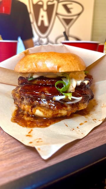 A promotional video for a burger restaurant showcasing new menu items, including a voting process for customers to choose their favorite burger.