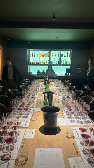 A short video showcasing an exclusive wine tasting event featuring Vietti Barolo wines at Osteria Bocconcino. The footage pans across a long table set with multiple wine glasses and bottles, followed by a shot of the guests attending the event.
