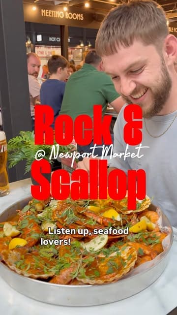 A high-energy vlog featuring two creators reviewing a seafood boil at Rock & Scallop in Newport Market. The video highlights the generous portion sizes, the 'VIP' and 'Classic' lunch deals, and the messy, hands-on experience of eating the meal.