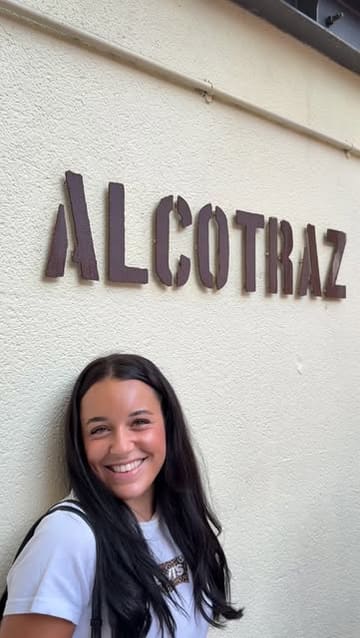 A couple visits the Alcotraz prison-themed cocktail bar, showcasing the immersive experience of wearing jumpsuits, interacting with actors playing prison guards, and having custom cocktails made from alcohol they smuggled in.