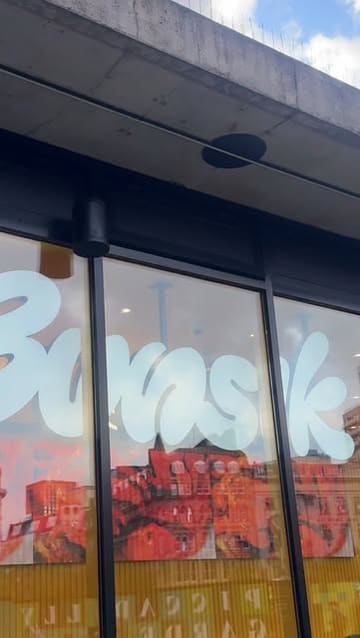 A couple visits Bunsik in Manchester to try Korean street food, showcasing a variety of dishes including a cheese-filled corn dog, kimbap, tteokbokki, and katsu curry.