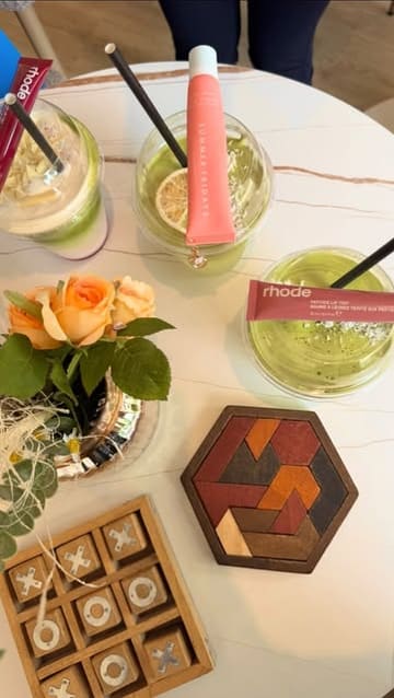 A montage video capturing a 'Pilates & Padel' event, featuring clips of participants exercising, playing padel, and enjoying healthy matcha drinks and açaí bowls. The video highlights the community aspect and the various amenities available at the venues.