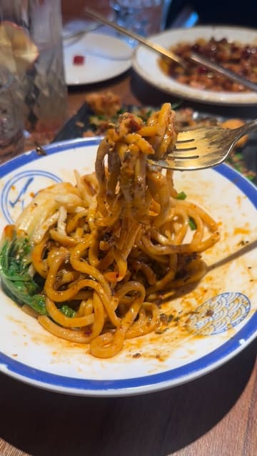 A montage of various Sichuan dishes at a Michelin-listed restaurant in Soho, featuring close-ups of salt and pepper chicken, gong bao chicken, stir-fried lamb, dumplings, Dan Dan noodles, and a glutinous rice cake dessert.