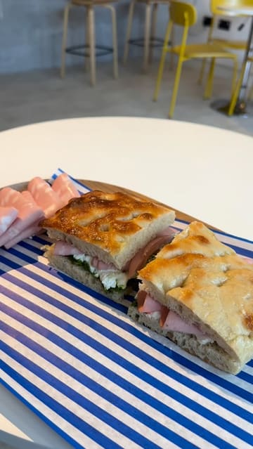 A short vlog-style review of Brechdan cafe in Llanelli, featuring the exterior, interior, and a selection of their focaccia sandwiches and coffee.