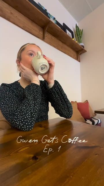 A vlog-style video introducing a new series called 'Gwen Gets Coffee,' featuring a visit to the newly opened Moth Coffee in Llanelli. The creator highlights the cozy interior, the piano, the menu, and specific items like the dirty banana chai and cakes.