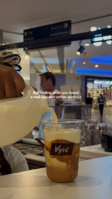 A short, edited montage showcasing the preparation of an açai bowl and a coffee at a cafe called Vyve.