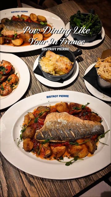 A montage-style video showcasing a variety of dishes at Bistrot Pierre, including sea bass, prawns, brie, and desserts, set to music with text overlays describing the dining experience.