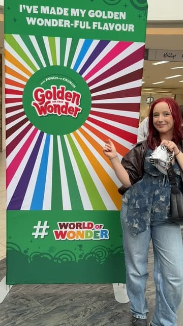 A creator visits a Golden Wonder pop-up event in a shopping centre, where they select a base and seasonings to create their own custom crisp flavour, shaking the bag to mix them.