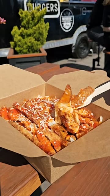 A montage showcasing the menu and various food items from a street food truck, including loaded fries, burgers, and a dessert waffle.