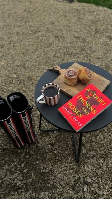 A couple shares a cozy morning routine during a stay at a shepherd's hut in the Yorkshire countryside, featuring coffee, pastries, a hot tub, and scenic walks.