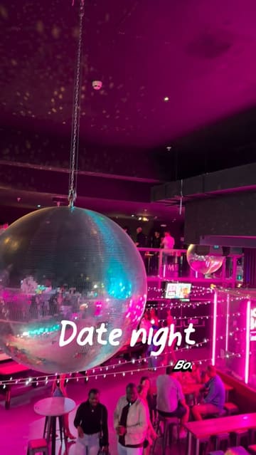 A fast-paced, energetic reel showcasing a date night at Boom Battle Bar. The video highlights various interactive games like darts, shuffleboard, and beer pong, alongside shots of drinks and bar food, effectively capturing the venue's lively atmosphere.
