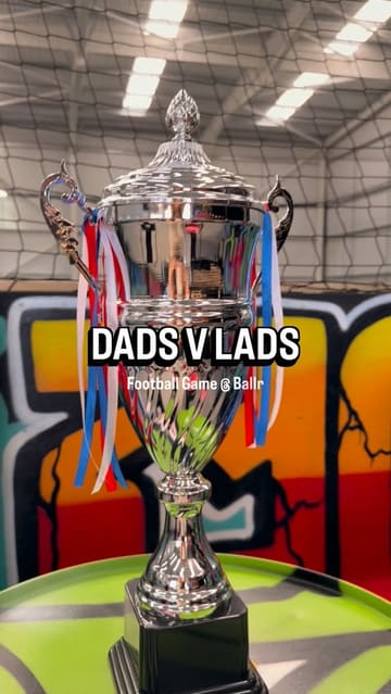 A high-energy, vlog-style reel showcasing an indoor football venue called Ballr Social, featuring a 'Dads vs Lads' match, the bar area, and gaming stations.