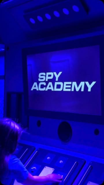 A vlog-style video showcasing a child's experience at the Spy Academy escape room in Edinburgh, followed by a pizza meal from Pizza Post, highlighting it as a great option for family days out or birthday parties.