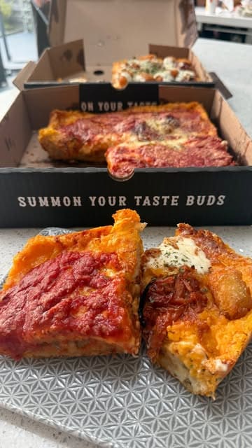 A short, punchy video showcasing Detroit-style pizzas, focusing on the cheesy edges and toppings.