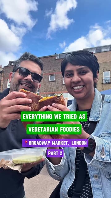 A couple visits Broadway Market in London to sample various vegetarian and vegan street food offerings, including Japanese onigiri, Indian samosas, Indonesian jackfruit rendang, iced chai, masala dosa, and Egyptian coffee. The video provides a quick review of each item, highlighting the variety and quality of food available at the market.