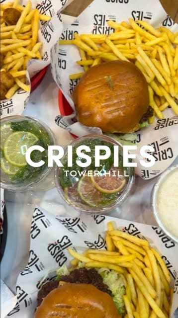 A review of the Crispies restaurant in Tower Hill, showcasing their menu of burgers, chicken wings, fries, and shakes, while highlighting the spacious interior and halal options.