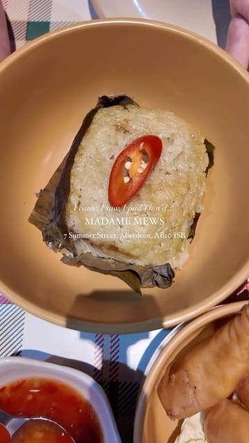 A personal, nostalgic reel documenting a return visit to a Thai restaurant in Aberdeen, featuring shots of spring rolls, sticky rice, and pad thai, alongside glimpses of the restaurant's interior.