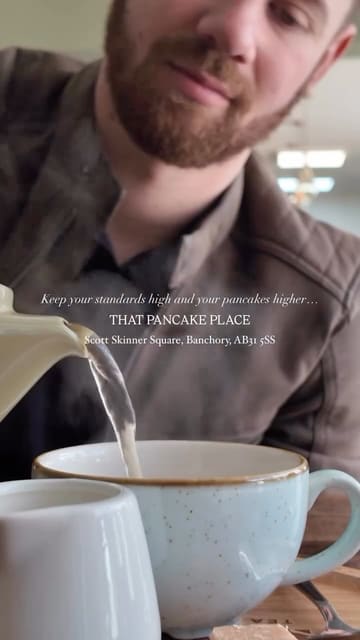 A short, engaging reel featuring a visit to 'That Pancake Place' in Banchory. The video highlights a variety of sweet and savoury pancakes, along with coffee and matcha drinks, set to a relaxed soundtrack. It captures the casual, spontaneous nature of the visit with quick, well-composed shots of the food and the venue's interior.