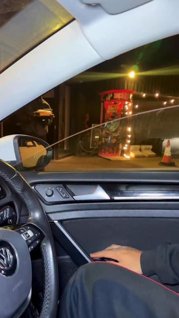 A short video showcasing a variety of Pakistani street food dishes purchased from a drive-thru venue. The video features close-up shots of the food in containers, including samosa chaat, biryani, butter chicken, and milk cake, filmed from inside a car.