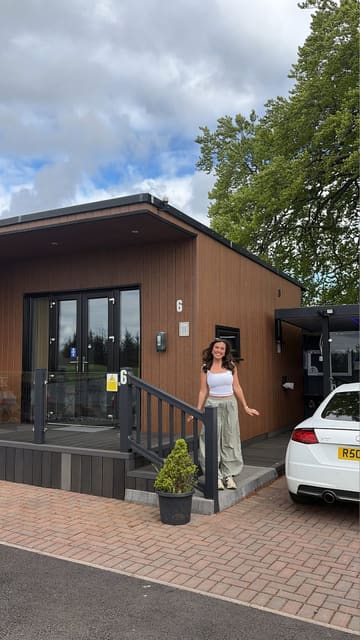 A vlog-style video showcasing a stay at a lochside lodge, featuring the accommodation interior, the hot tub, and the surrounding area.