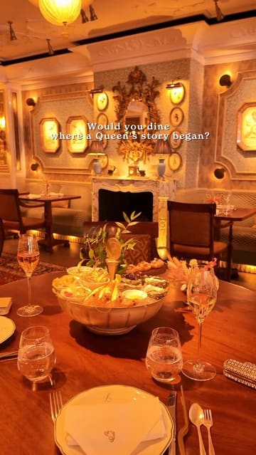 A polished venue tour of Lilibet's in Mayfair, highlighting its historic connection to Queen Elizabeth II, elegant interior, and high-end Sunday lunch offerings including a seafood platter and flaming dessert.