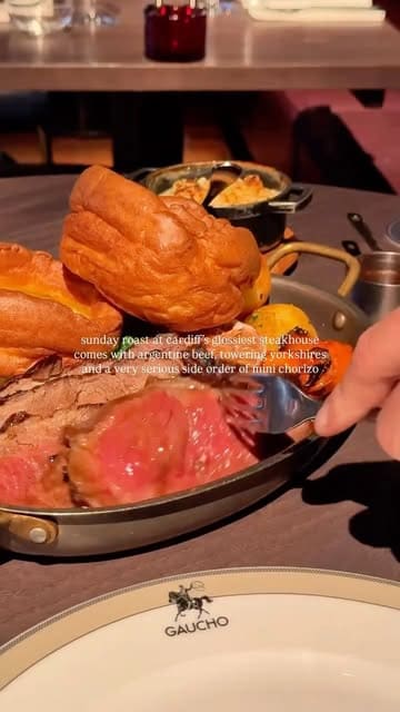 A promotional video for Gaucho Cardiff featuring their Sunday roast offering, including shots of the venue interior, starters like burrata and empanadas, the main roast beef sharing platter with unlimited Yorkshire puddings, and dessert.