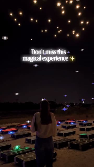 A montage video showcasing a drone art show in Dublin, featuring over 1200 drones creating light displays in the night sky accompanied by a live string quartet and a candlelit setting.