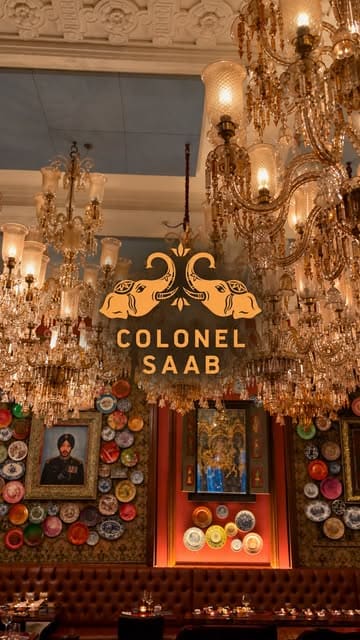 A visually stunning montage showcasing the opulent interior of Colonel Saab, featuring close-ups of Indian cuisine, cocktails, and the restaurant's dramatic decor.