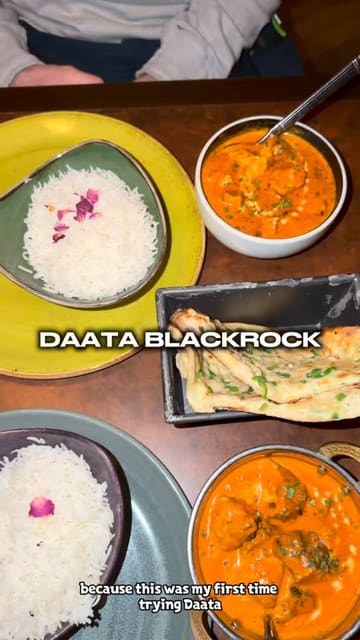 A short, engaging video review of Daata restaurant in Dublin. The creator shares their first-time experience, highlighting the interior, the menu, and specific dishes like butter chicken, chilli cheesy naan, and a sizzling brownie. The video uses a voiceover to guide the viewer through the meal.