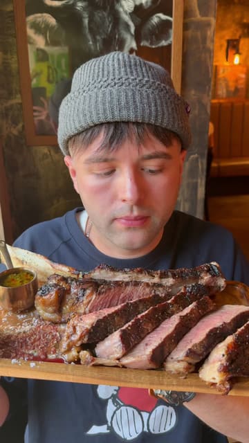 The creator visits El Toro Gaucho, a steakhouse, providing a comprehensive review of the experience. They highlight the service, specifically the server presenting raw cuts of meat, and showcase a variety of dishes including a large tomahawk steak, salmon, and desserts.