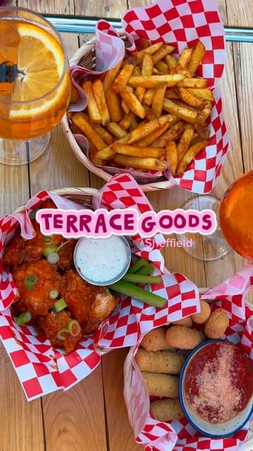A short, energetic review of Terrace Goods in Sheffield, featuring a variety of comfort food dishes like fries, mozzarella sticks, and wings, alongside cocktails, showcasing the venue's vibrant atmosphere.