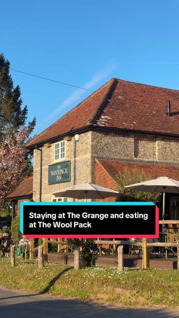 A travel and lifestyle reel showcasing a weekend stay at The Clock Tower on The Grange estate in Hampshire, followed by a dinner experience at The Woolpack Inn. The video features shots of the accommodation, the pub's outdoor terrace, and various dishes including camembert, stone bass, and steak.