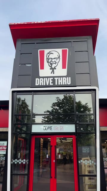 A candid, handheld vlog-style review of the new KFC Tandoori Chicken Burger, covering the ordering process at the drive-thru and a taste test of the burger, fries, and chicken tenders.