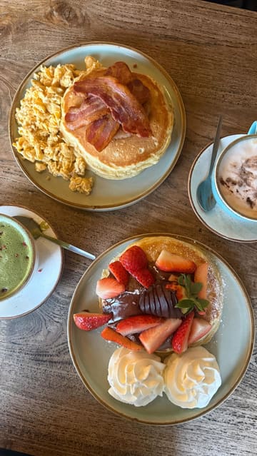 A promotional reel for The Cabin in Sheffield, highlighting their pancake offerings for Pancake Day. The video features close-ups of 'The Works' and 'Strawberry & Nutella Heaven' pancakes, along with branded coffee art and the cozy, cabin-themed interior.
