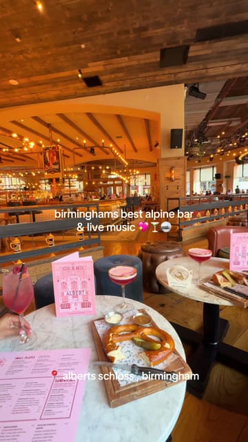 A fast-paced video tour of Albert's Schloss in Birmingham, highlighting the alpine-inspired decor, live music, shuffleboard, and cocktail offerings.