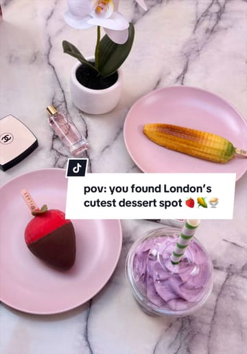 The video features a series of close-up shots of various gelato desserts, including a corn-shaped gelato and a strawberry-shaped gelato, alongside a purple ube matcha drink. The creator is shown holding and eating the desserts in a bright, pink-themed setting.