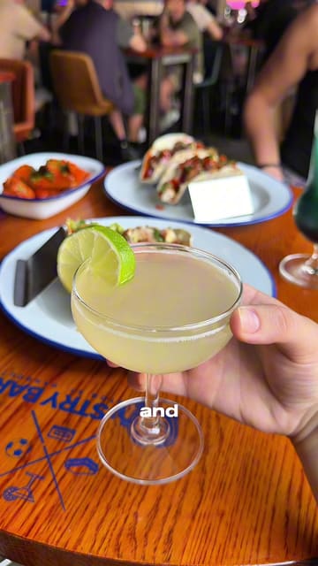A fast-paced review of Industry Bar in Nottingham, highlighting their new food and drink menu, including cocktails like the Shark Attack and Pineapple Daiquiri, as well as tacos and buffalo wings.
