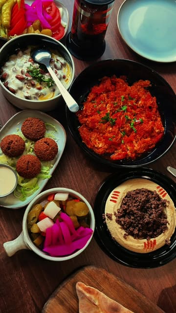 A short, visually focused reel showcasing a Middle Eastern brunch spread at Mraya in Nottingham. The video features close-up shots of various dishes including shakshuka, hummus, falafel, and kunafah, alongside brief glimpses of the restaurant's interior.