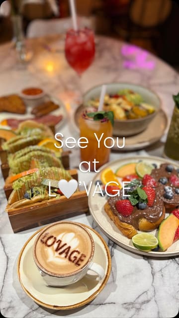 A short, aesthetic montage showcasing a variety of brunch and lunch items at Lovage. The video features close-ups of cocktails, smoothies, coffee, and various plated dishes like French toast and a full English breakfast, set to music with simple text overlays.