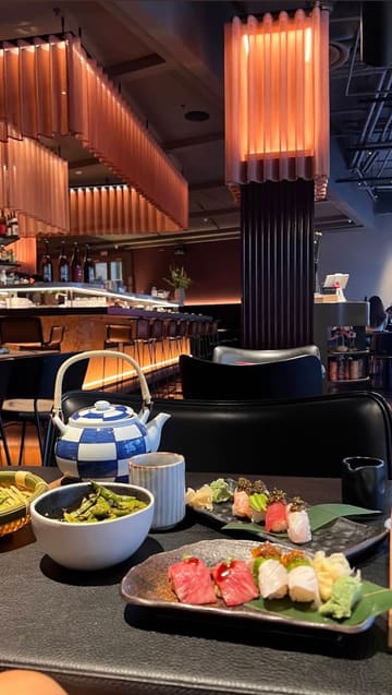A montage showcasing the interior and various sushi and yakitori dishes at Stick'n'Sushi in Battersea. The video highlights the restaurant's aesthetic and food presentation through a series of clean, well-lit shots.