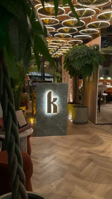 A montage video showcasing the interior and menu of Kobe Mayfair, featuring shots of the dining room, table settings, and various dishes including steak, tartare, and desserts.