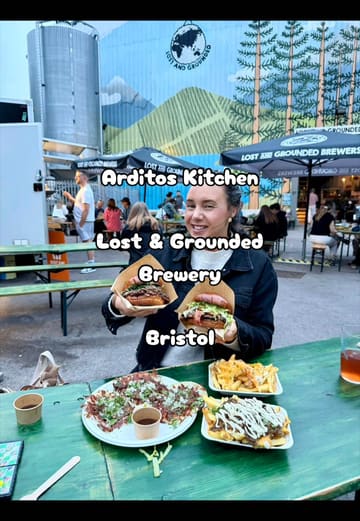 A food blogger reviews the menu from Arditos Kitchen, a pop-up street food vendor located at Lost and Grounded Brewers in Bristol, showcasing birria tacos, loaded fries, and burgers.