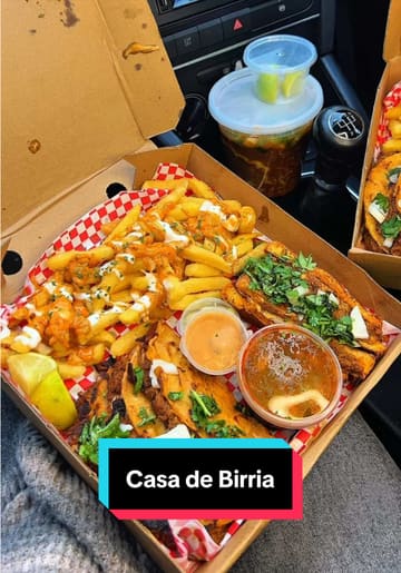 A short video showcasing a takeaway order from Casa De Birria, featuring birria tacos, loaded fries, and birria ramen. The video focuses on the food, demonstrating the dipping process and the quality of the ingredients.