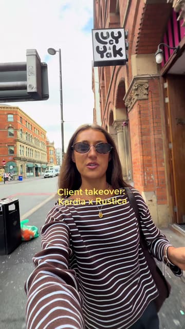 A promotional vlog documenting a PR takeover event where a Greek kitchen concept, Kardia, launched at the Rustica sandwich shop. The video features the creator walking through the event, showing the queue, the branding, and the gyros being served to customers.