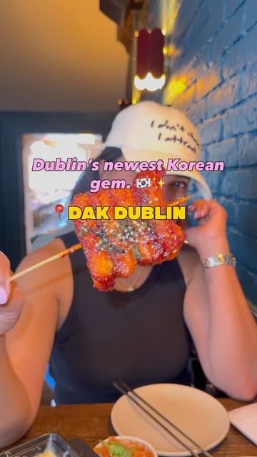 A fast-paced, energetic review of Dak Dublin, a Korean restaurant. The video features a variety of dishes including Korean fried chicken, corn cheese, tteok skewers, and desserts, alongside drinks like somak. The creator showcases the venue's interior and shares their positive experience.