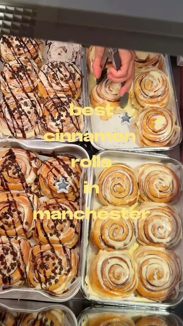 A creator visits Rollers in Manchester to review their cinnamon rolls. The video follows the journey from arriving at the shopping centre to the shop, showing the variety of flavours available, the packaging process, and a final taste test of a warm, gooey cinnamon roll.