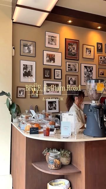 A short, aesthetic montage showcasing the interior and exterior of BRÜE coffee shop on Fulham Road, London, featuring shots of the coffee machine, decor, and a finished drink.