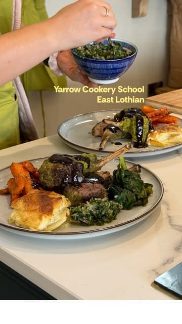 A vlog-style review of a cookery class at Yarrow Cookery School, showing the process of preparing a meal (herb-crusted rack of lamb, dauphinoise potatoes, honey-roasted carrots) and the social experience of the class.