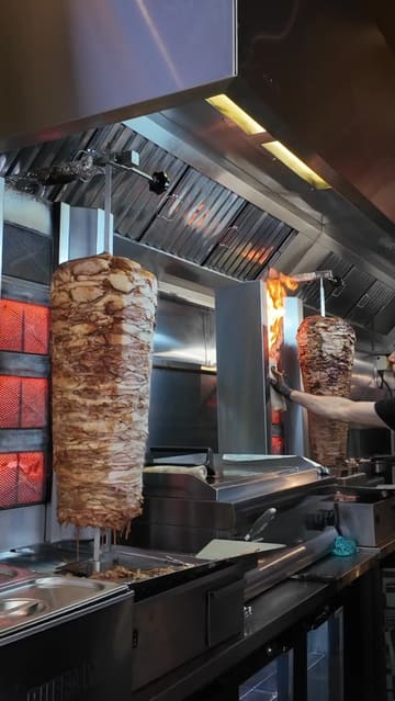 A review of Cha Cha, a shawarma spot in Edinburgh. The video features the preparation of the shawarma, a look at the menu, and the creator trying the food.